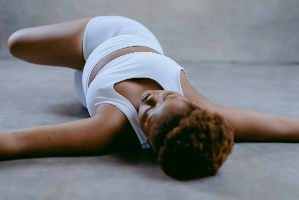 Person lying in a relaxed position demonstrating inclined sleep posture to reduce reflux symptoms.