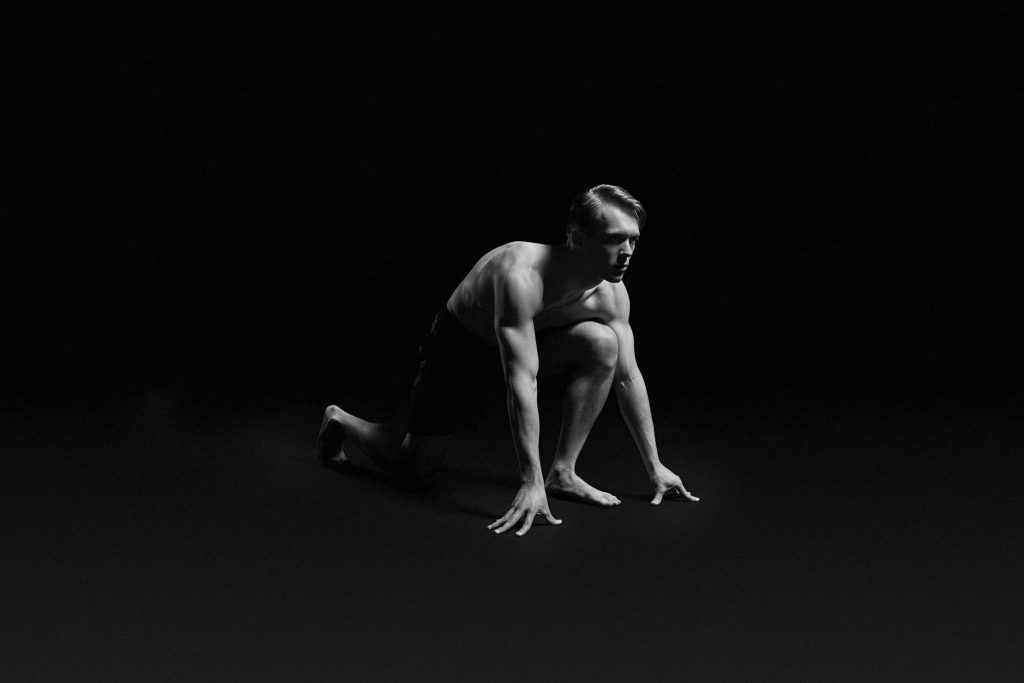 Bailey running outdoors, mid-stride, in athletic sportswear.