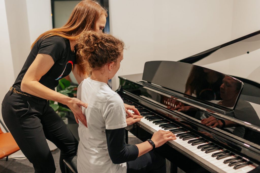 Musical theatre physio providing hands-on treatment to a performer backstage